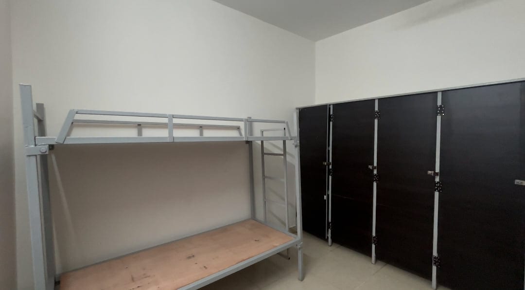 A hostel room at Mandaara Public School, with a bunk bed and a row of lockers along the wall.